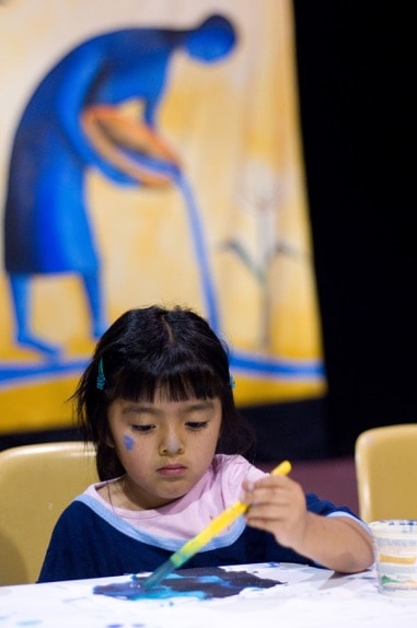 child-with-banners Making thank you paintings during “Decorate the Well in Gratitude”